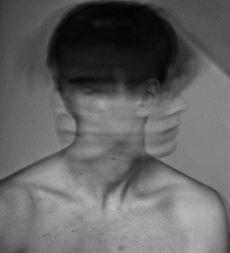 blurred image of a man moving his head from side to side as if distracted