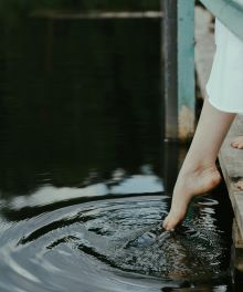 a toe being dipped into water