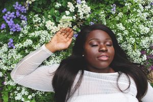 young woman relaxing on a bed of flowers