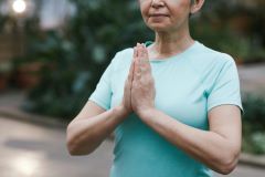 woman with her hands in a prayer position